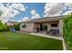 Spacious backyard with lush artificial grass, a playset, and a covered patio area for outdoor enjoyment at 12289 E Ballentine Rd, Gold Canyon, AZ 85118