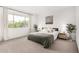 Bright bedroom featuring a large window, neutral decor, and cozy bedding at 12289 E Ballentine Rd, Gold Canyon, AZ 85118