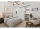 Comfortable bedroom featuring a ceiling fan, neutral tones, and easy access to the laundry area at 12289 E Ballentine Rd, Gold Canyon, AZ 85118
