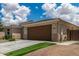 Charming two-car garage with desert landscaping and a synthetic grass accent at 12289 E Ballentine Rd, Gold Canyon, AZ 85118