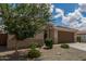 Single-story home with a well-kept yard, two-car garage, neutral colors and desert landscaping at 12289 E Ballentine Rd, Gold Canyon, AZ 85118