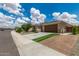 Beautiful home with desert landscaping, a two-car garage and artificial turf at 12289 E Ballentine Rd, Gold Canyon, AZ 85118