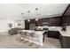Bright kitchen with stainless appliances, island with seating, and an open floorplan at 12289 E Ballentine Rd, Gold Canyon, AZ 85118