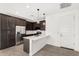 Modern kitchen with stainless steel appliances, pendant lighting, and ample counter space at 12289 E Ballentine Rd, Gold Canyon, AZ 85118