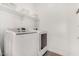 Laundry room with front load washer and dryer and decorative shelves for storage at 12289 E Ballentine Rd, Gold Canyon, AZ 85118