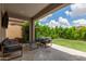 Relaxing covered patio with comfortable seating and a view of the beautifully landscaped backyard at 12289 E Ballentine Rd, Gold Canyon, AZ 85118