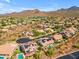 Community aerial showcases homes with desert landscaping, mountain views at 12605 E Kalil Dr, Scottsdale, AZ 85259