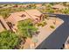 Home aerial view featuring desert landscaping, tile roof, and surrounding neighborhood in a community setting at 12605 E Kalil Dr, Scottsdale, AZ 85259