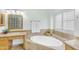 Bathroom features a soaking tub with shutters, granite counters, and tile flooring for a spa-like experience at 12605 E Kalil Dr, Scottsdale, AZ 85259
