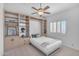 Bedroom features built-in shelves, a Murphy bed, a window with shutters, and carpet flooring at 12605 E Kalil Dr, Scottsdale, AZ 85259