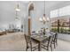 Spacious dining room with large windows, chandelier, and open access to the adjacent living area at 12605 E Kalil Dr, Scottsdale, AZ 85259