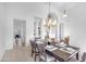 Elegant dining room featuring a chandelier, table set for six, and views into adjacent rooms at 12605 E Kalil Dr, Scottsdale, AZ 85259