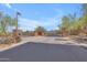 Gated community entrance with stone pillars and desert landscaping offering security and visual appeal at 12605 E Kalil Dr, Scottsdale, AZ 85259