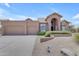 Attractive single-story home featuring a three-car garage and desert landscaping at 12605 E Kalil Dr, Scottsdale, AZ 85259