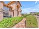 Inviting exterior showcasing a tiled pathway, lush green bushes, and manicured desert landscaping at 12605 E Kalil Dr, Scottsdale, AZ 85259