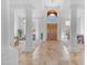 Expansive foyer with tiled flooring, soaring ceilings, and classic columns leading to the living space at 12605 E Kalil Dr, Scottsdale, AZ 85259