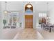 Grand foyer featuring high ceilings, arched windows, tile flooring, and an elegant dining area at 12605 E Kalil Dr, Scottsdale, AZ 85259
