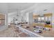Spacious open kitchen featuring granite counters, stainless appliances, and view into living and dining spaces at 12605 E Kalil Dr, Scottsdale, AZ 85259