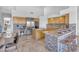 Beautiful kitchen with breakfast bar seating, stainless steel fridge, and seamlessly connects to the dining area at 12605 E Kalil Dr, Scottsdale, AZ 85259