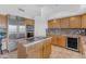 Spacious kitchen featuring stainless steel appliances, granite countertops, and custom cabinetry at 12605 E Kalil Dr, Scottsdale, AZ 85259