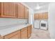 Functional laundry room with plenty of counter space, sink, cabinets and tile floors at 12605 E Kalil Dr, Scottsdale, AZ 85259