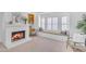 Cozy living room with a white fireplace, built-in desk, and window seat perfect for relaxing by the bright window at 12605 E Kalil Dr, Scottsdale, AZ 85259
