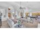 Bright and airy living room featuring arched doorways, white sofas, and modern decor at 12605 E Kalil Dr, Scottsdale, AZ 85259