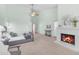 Bright primary bedroom with fireplace, sitting area, plush carpet, and a ceiling fan at 12605 E Kalil Dr, Scottsdale, AZ 85259
