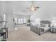 Spacious primary bedroom with a sitting area, fireplace, plush carpet, and a ceiling fan at 12605 E Kalil Dr, Scottsdale, AZ 85259
