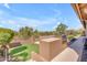 View of outdoor kitchen and grill area featuring stone countertop and grassy space and outdoor living at 12605 E Kalil Dr, Scottsdale, AZ 85259