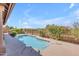 Beautiful backyard pool surrounded by mature landscaping and blue skies for relaxing and play at 12605 E Kalil Dr, Scottsdale, AZ 85259