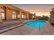 Sparkling backyard pool with stairs, manicured landscaping and an inviting patio area at 12605 E Kalil Dr, Scottsdale, AZ 85259