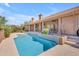 Inviting backyard pool with tiled edge and patio surrounded by lush landscaping and outdoor living space at 12605 E Kalil Dr, Scottsdale, AZ 85259