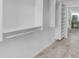 Spacious walk-in closet with custom shelving and storage solutions leading to the bathroom at 12605 E Kalil Dr, Scottsdale, AZ 85259