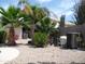 Well-maintained backyard with pool equipment, various palm trees and a gravel bed at 1333 N Higley Rd # 7, Mesa, AZ 85205