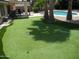 Lush backyard featuring a refreshing pool, putting green, and comfortable lounge seating for relaxation at 1333 N Higley Rd # 7, Mesa, AZ 85205
