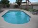 Lush backyard featuring a refreshing pool, putting green, and comfortable lounge seating for relaxation at 1333 N Higley Rd # 7, Mesa, AZ 85205