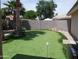 An ample backyard area boasts a putting green, offering leisure and entertainment at this home at 1333 N Higley Rd # 7, Mesa, AZ 85205