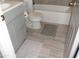 Bathroom with tiled flooring, gray vanity with storage, commode, and soaking tub at 1333 N Higley Rd # 7, Mesa, AZ 85205
