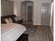 Bedroom featuring a comfortable bed, a futon, and a decorative area rug on plank flooring at 1333 N Higley Rd # 7, Mesa, AZ 85205