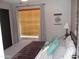 Comfortable bedroom with cozy bedding, stylish curtains, and a decorative wall hanging at 1333 N Higley Rd # 7, Mesa, AZ 85205