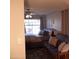 Comfortable bedroom features a bed, futon, ceiling fan and a window with a view at 1333 N Higley Rd # 7, Mesa, AZ 85205