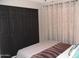 Bedroom with a soft color scheme, black closet, and plenty of natural light at 1333 N Higley Rd # 7, Mesa, AZ 85205