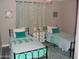 Cozy bedroom featuring two twin beds with matching turquoise accents and decorative wall art at 1333 N Higley Rd # 7, Mesa, AZ 85205