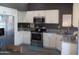 Updated kitchen with stainless steel appliances, white cabinets, and granite countertops at 1333 N Higley Rd # 7, Mesa, AZ 85205