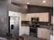 Bright kitchen features white cabinets, stainless steel appliances, and granite countertops at 1333 N Higley Rd # 7, Mesa, AZ 85205