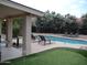 Relaxing outdoor pool area featuring lounge chairs and a charming putting green at 1333 N Higley Rd # 7, Mesa, AZ 85205