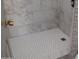 The walk-in shower features decorative tile, a shower curtain and sleek fixtures at 1333 N Higley Rd # 7, Mesa, AZ 85205