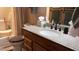 Bathroom vanity with light granite countertop and framed mirror at 1440 N Idaho Rd # 1022, Apache Junction, AZ 85119