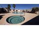 Resort-style community pool and spa area surrounded by palm trees and lounge chairs at 1440 N Idaho Rd # 1022, Apache Junction, AZ 85119